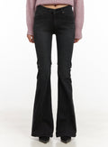 LEWKIN Belle Slim Fit Flared Jeans CD410 in black, front view on model, low-waist washed denim with slim thigh and wide flared hem, styled with pink knit sweater and black heels.
