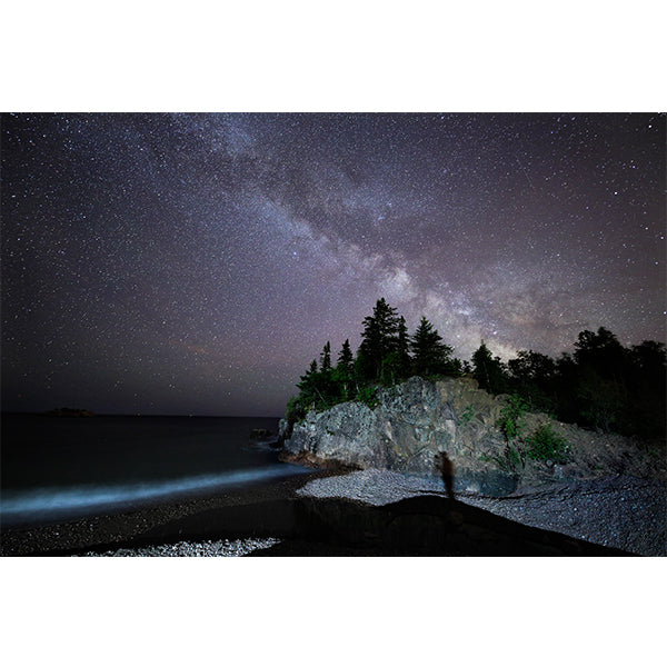 A photo print depicting the Milky Way above a lakeshore with trees and a rocky outcrop, near Silver Bay.