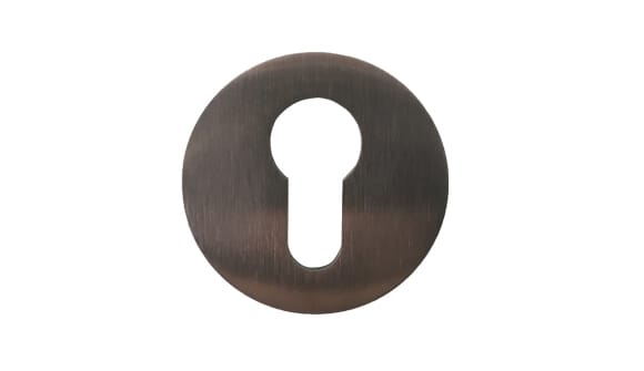 Bronze keyhole cover on a white background