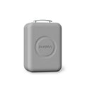 Gray hard-shell travel case with top handle and molded circular logo on front.
