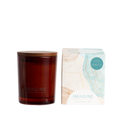 310g soy Limoncello scented candle from the Coastal collection in amber glassware, with its box featuring blue and sandy abstract coastal patterns.