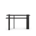 The Abstract Console by Ethnicraft is a modern black wooden table with clean geometric lines, an asymmetrical de Stijl-inspired design, two rectangular shelves, and unique vertical and horizontal supports. Shown on a plain white background.