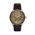 The Timex x Harry Potter Waterbury Skeleton Automatic TW2Y75500 features a gold skeletonized dial revealing the movement, with brown faceted crystals marking the hours. The Hogwarts crest sits at 12 o'clock.
