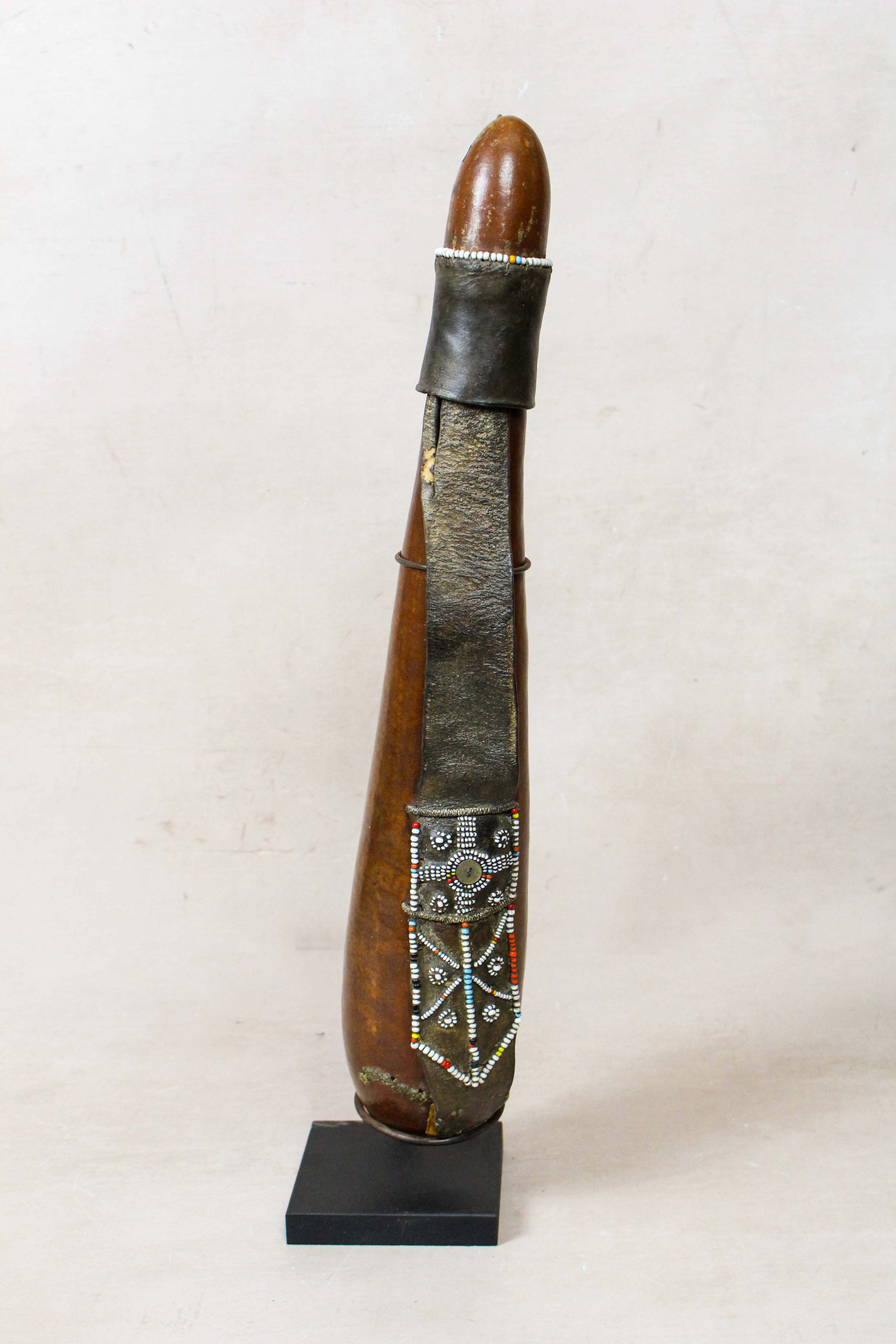 Vintage Maasai beaded calabash from Kenya, dried gourd with white, red and blue beadwork on leather straps