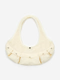 The Sam Pomeroy Cargo Handbag - Cream by Sam Pomeroy is a cream-colored, crescent-shaped handmade handbag featuring three front pockets with silver snap buttons. It boasts a wide strap and minimalist design, displayed against a plain white background.