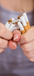 broken cigarettes in hands