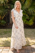Woman in a floral dress standing in front of tropical plants